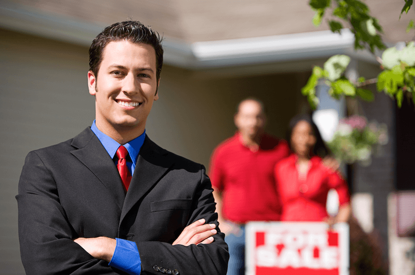 An estate agent showing a couple around a property